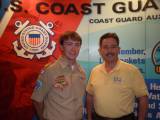 Keith Christopher, BSA's liaison to the Coast Guard Auxiliary, in front of the Auxiliary exhibit at the BSA National Meeting