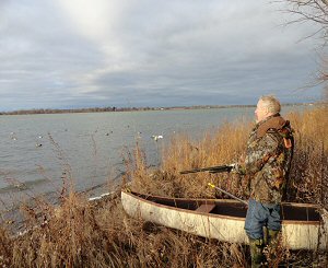 Grand Island, New York - A waterfowl hunter prepares to depart in a canoe to check on his duck decoys in the Niagara River (Photo by Paul Leuchner)